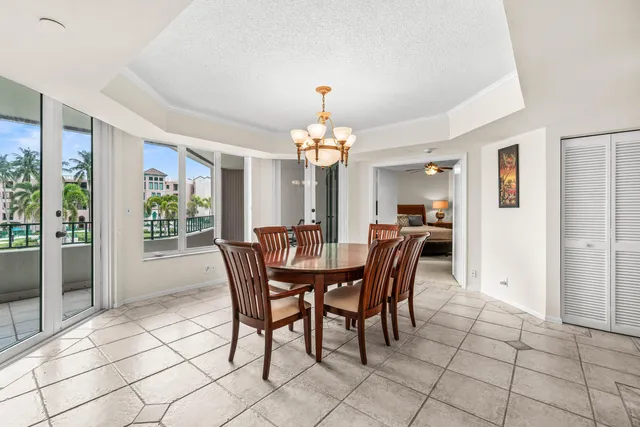 a dining room with furniture a chandelier and window