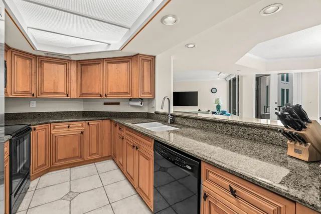 a kitchen with stainless steel appliances granite countertop a sink and cabinets