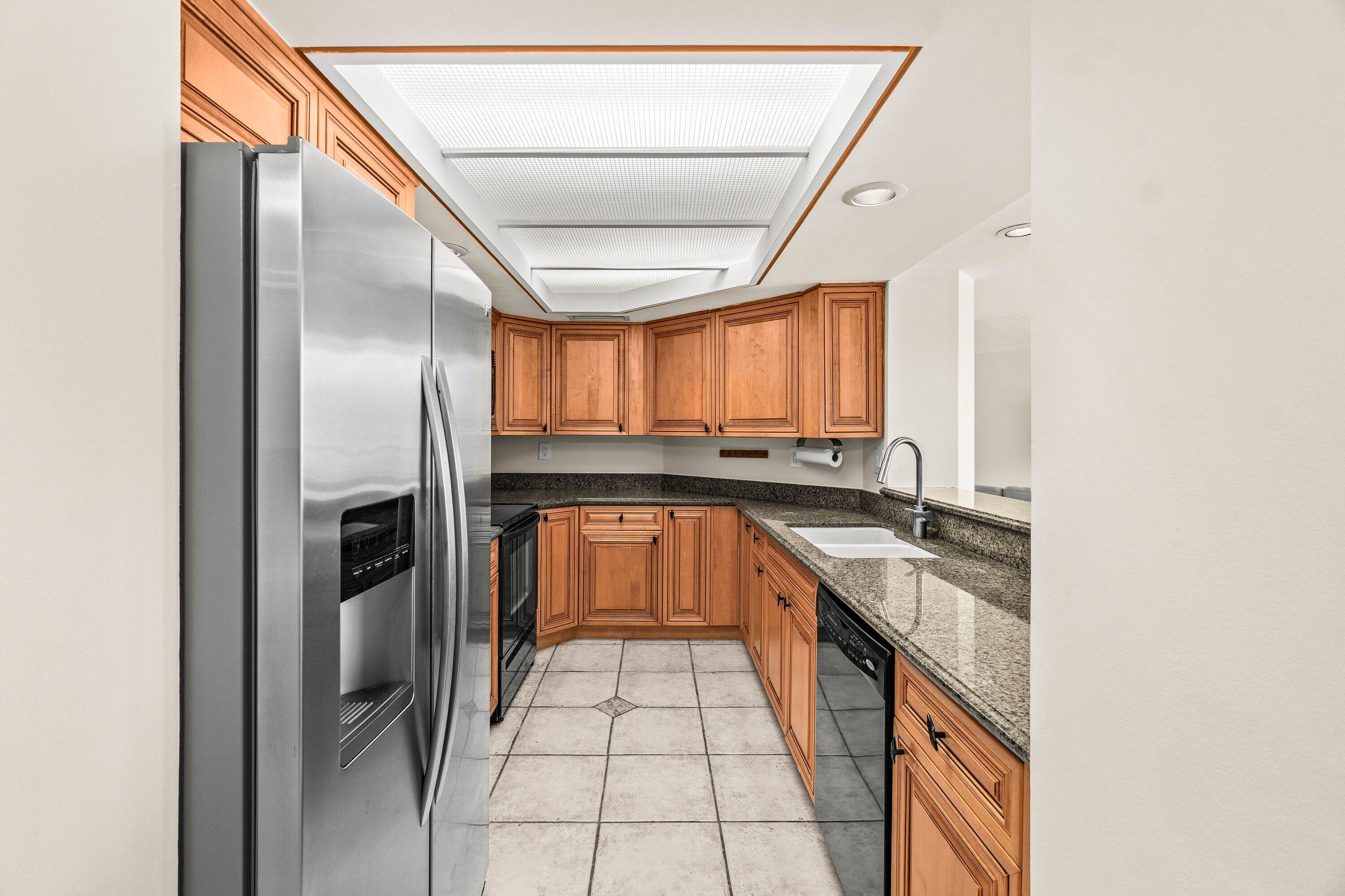 100 Southeast 5th Avenue, Unit 311 Boca Raton, FL 33432 - Photo 10 of 57 a kitchen with stainless steel appliances granite countertop a sink and a refrigerator