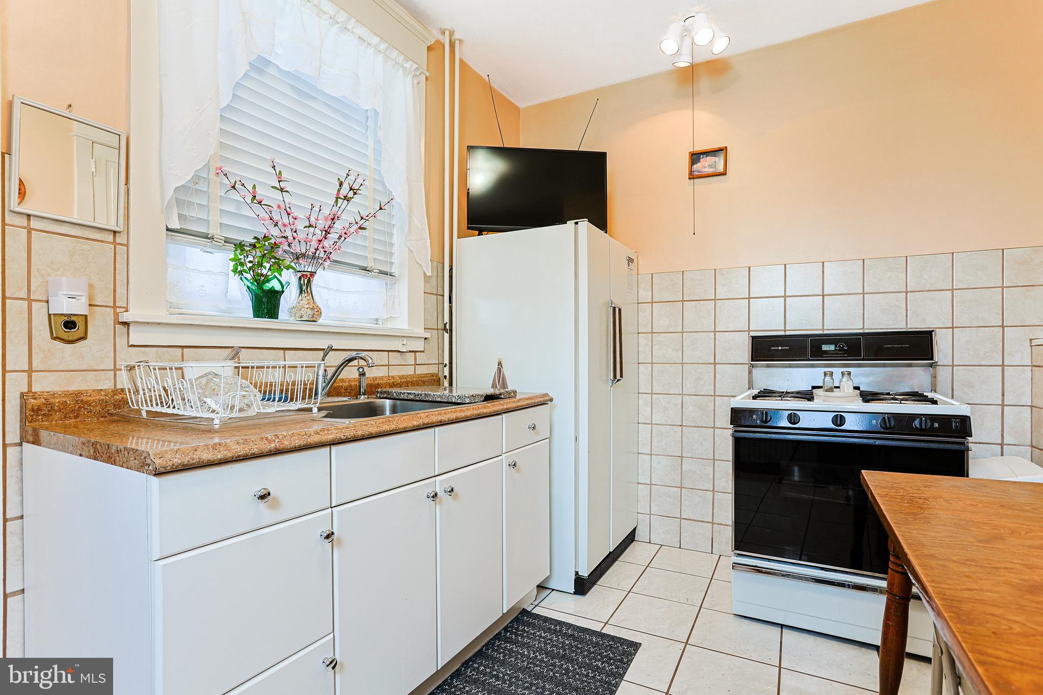 5236 Ridge Avenue Philadelphia, PA 19128 - Photo 12 of 45 a kitchen with a stove and a sink