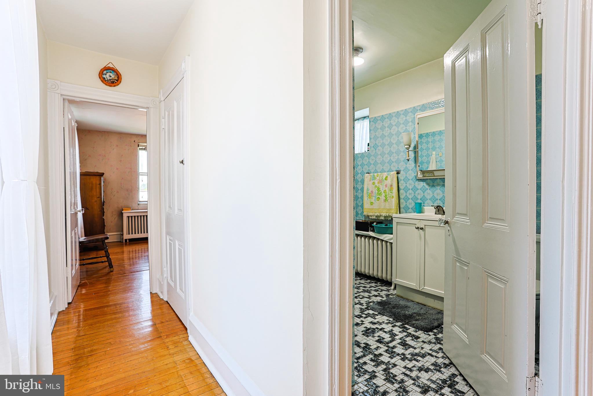 5236 Ridge Avenue Philadelphia, PA 19128 - Photo 23 of 45 a view of a hallway with wooden floor and a bathroom