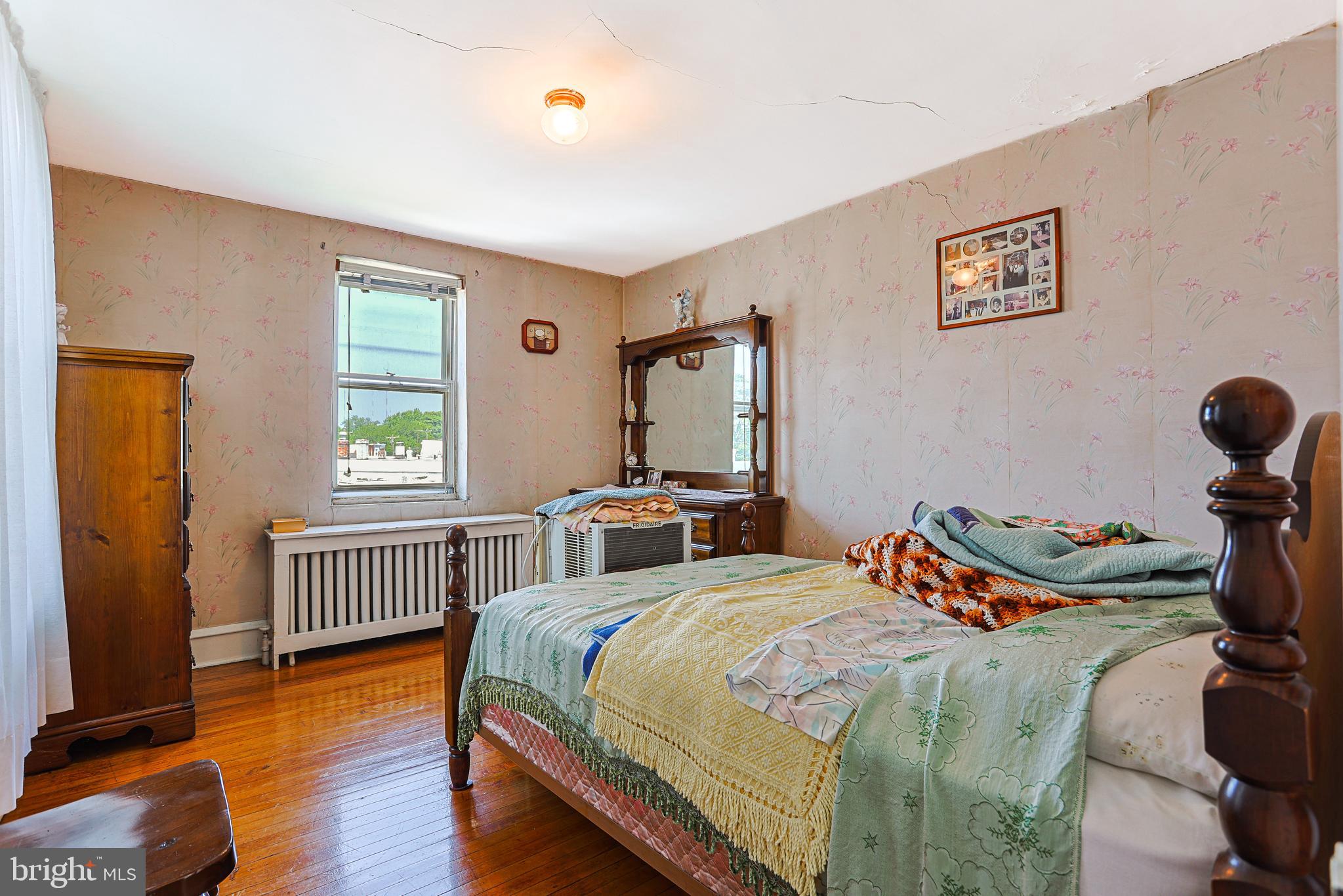 5236 Ridge Avenue Philadelphia, PA 19128 - Photo 24 of 45 a bedroom with a bed and wooden floor