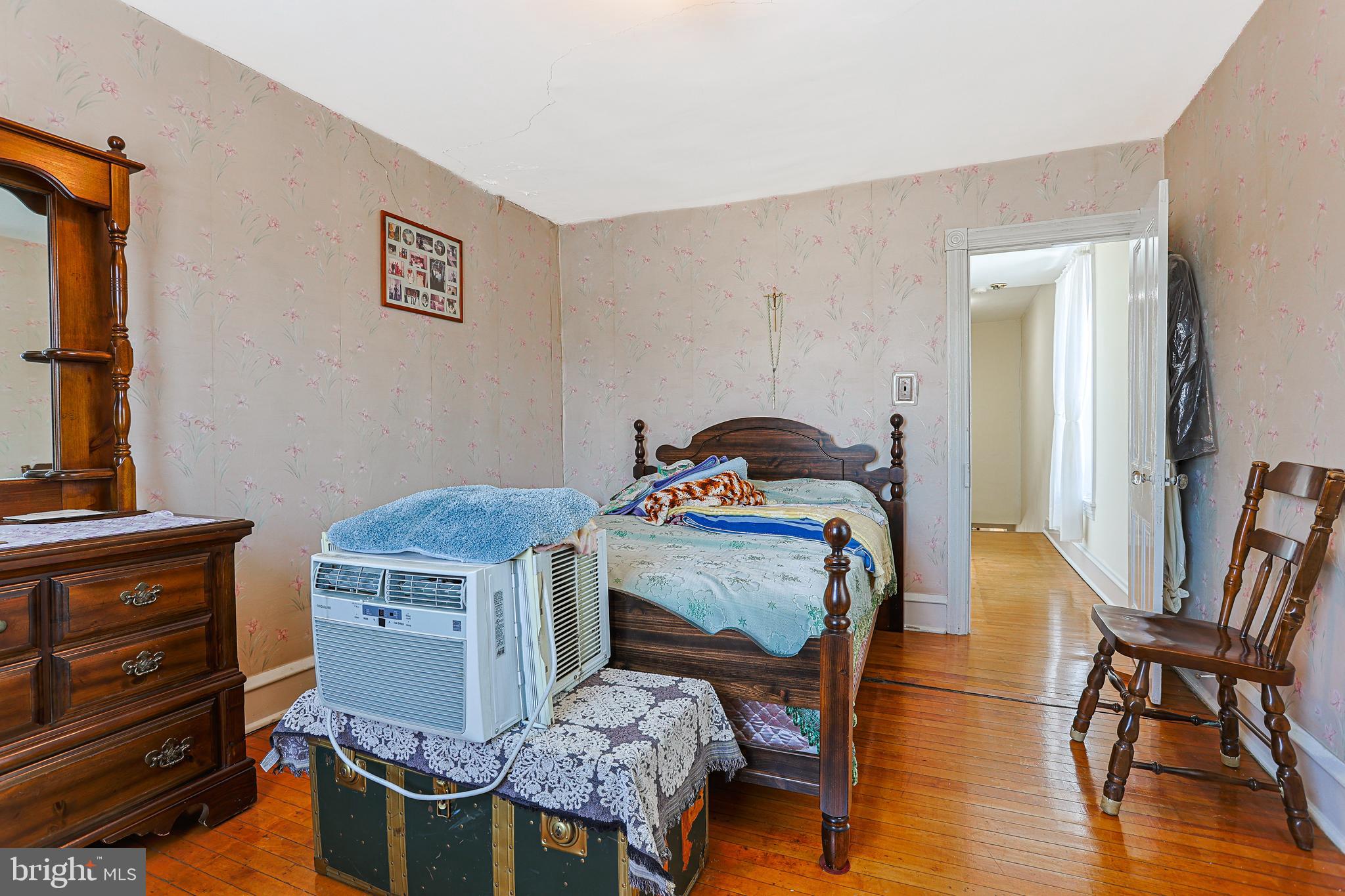 5236 Ridge Avenue Philadelphia, PA 19128 - Photo 25 of 45 a bedroom with a bed and wooden floor