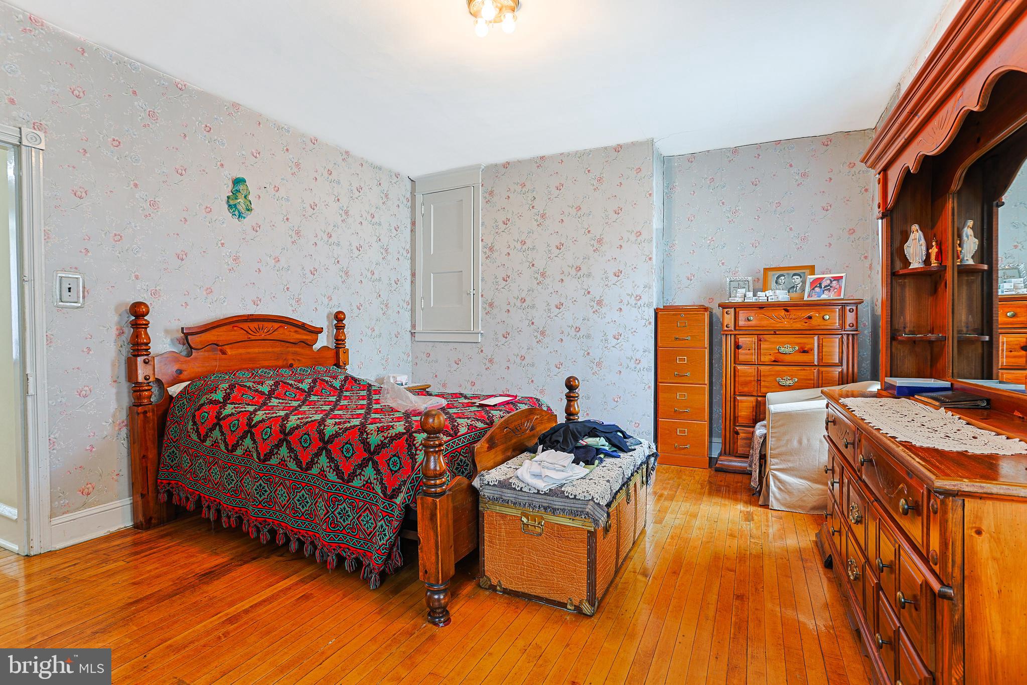 5236 Ridge Avenue Philadelphia, PA 19128 - Photo 31 of 45 a bedroom with a bed and dresser with racks on the dresser