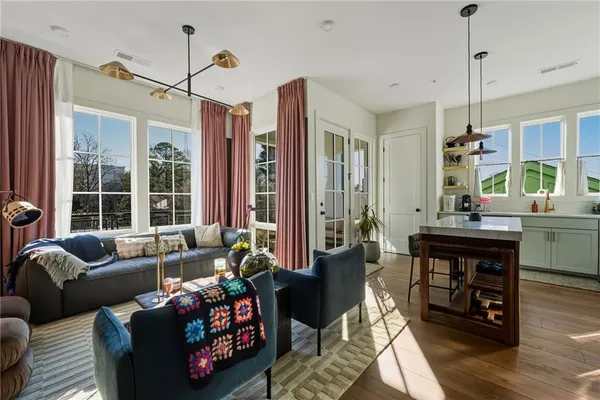 a living room with furniture fireplace and large windows