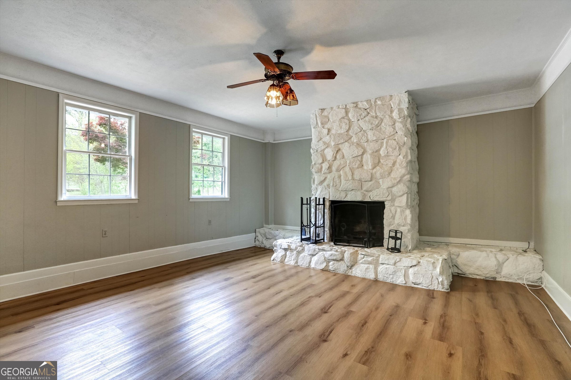 1095 Athens Road Winterville, GA 30683 - Photo 13 of 32 a view of a livingroom with wooden floor a fireplace and window