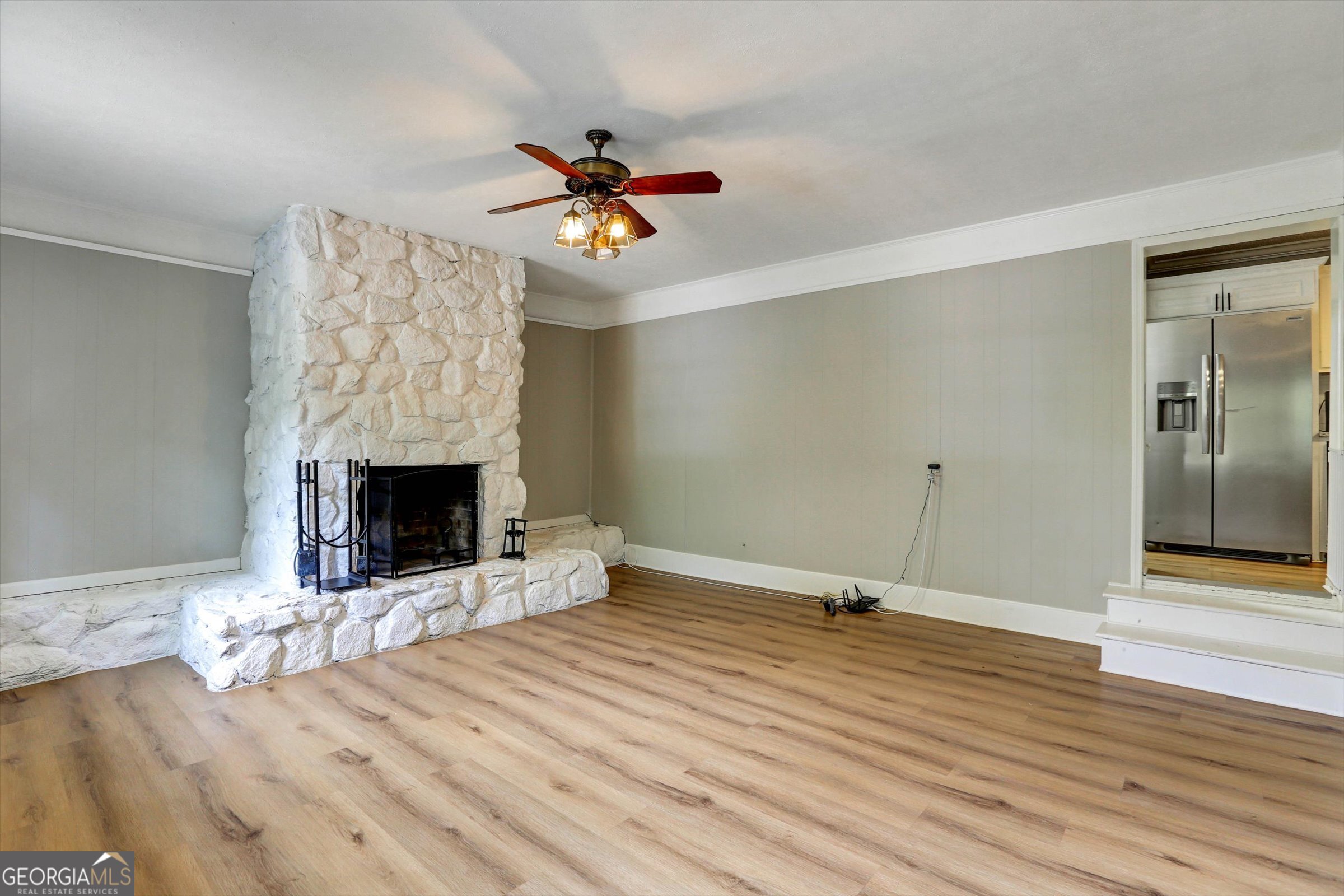 1095 Athens Road Winterville, GA 30683 - Photo 18 of 32 a view of an empty room with wooden floor fireplace and a window