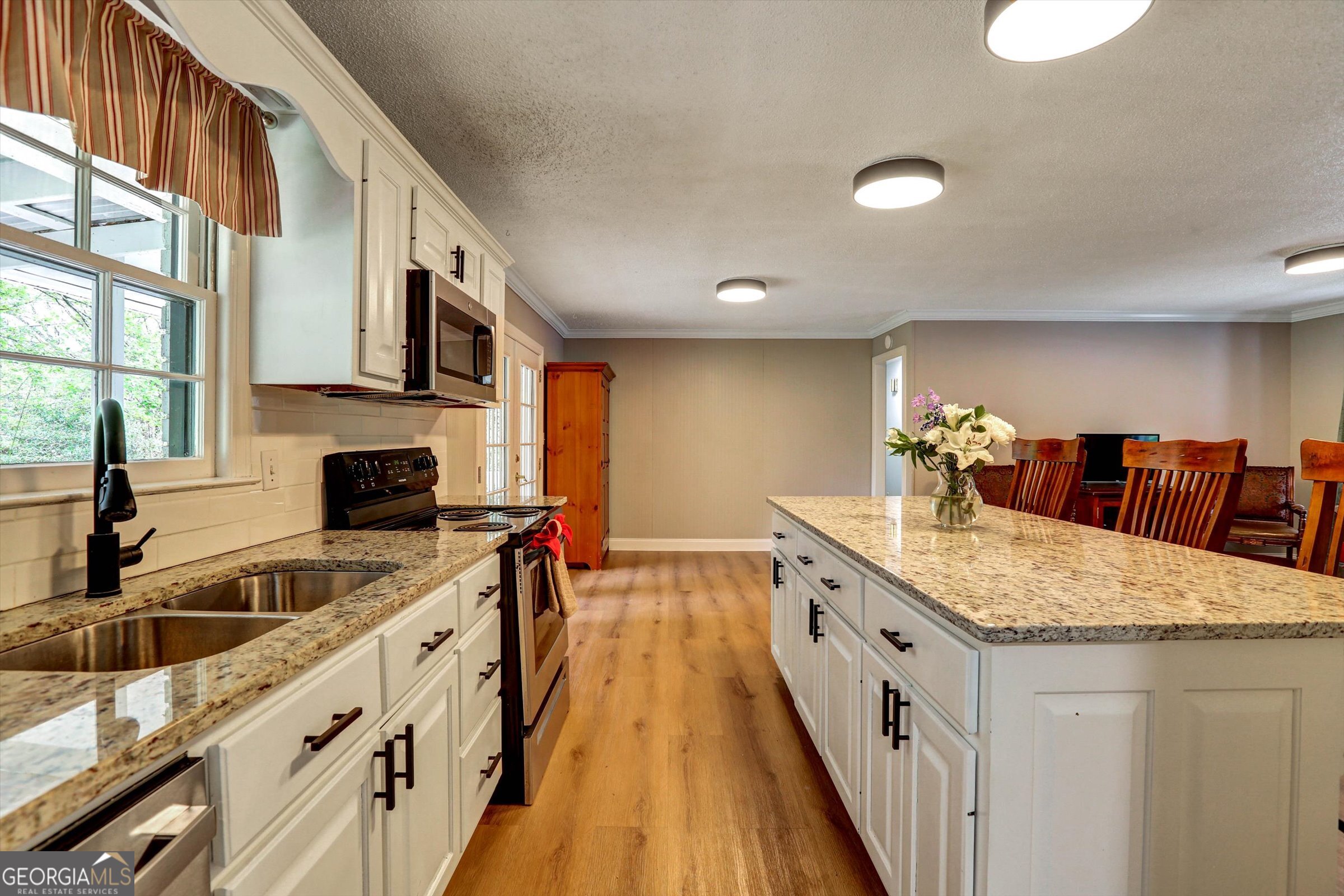 1095 Athens Road Winterville, GA 30683 - Photo 2 of 32 a kitchen with stainless steel appliances granite countertop a sink and stove