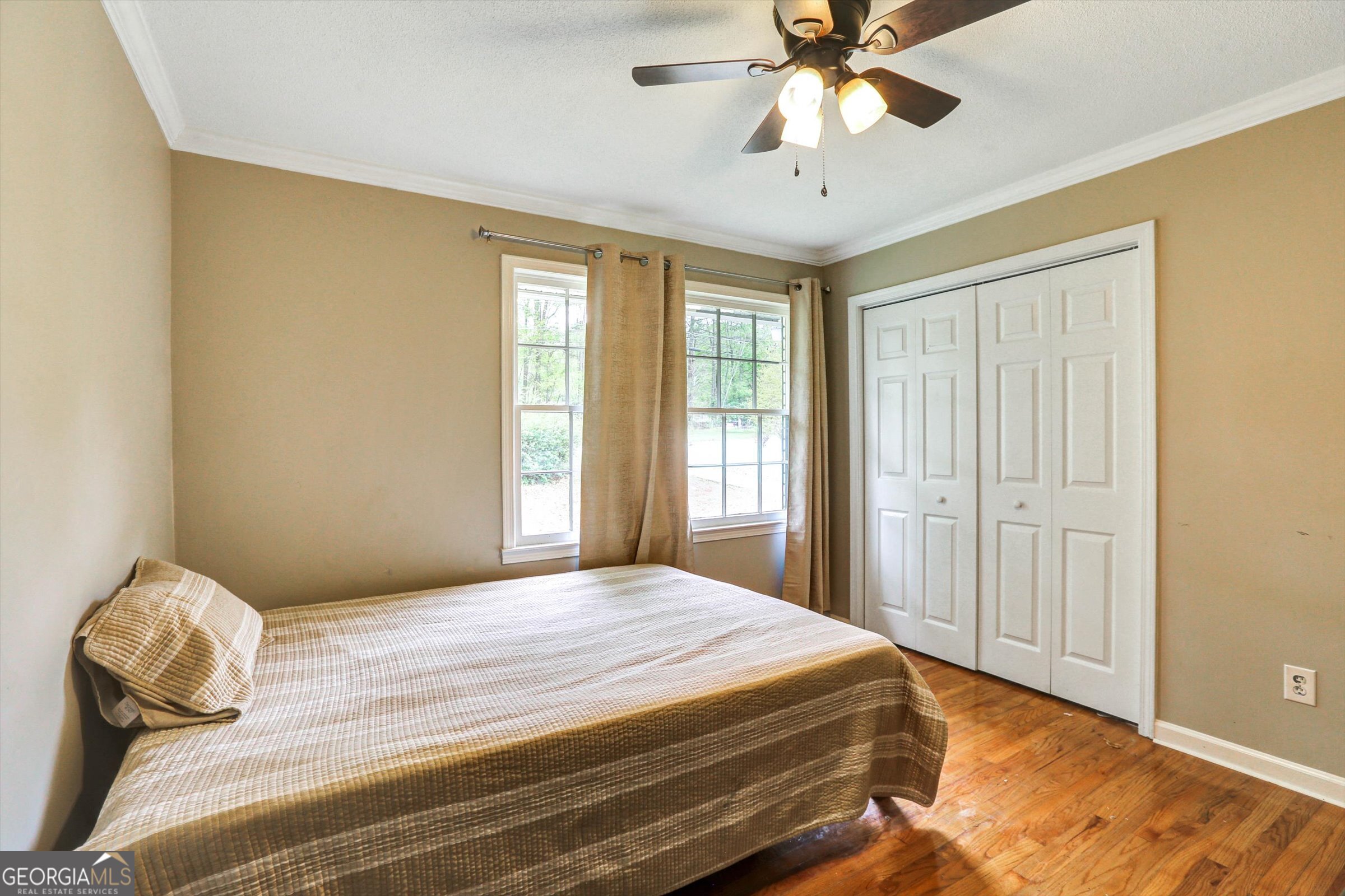 1095 Athens Road Winterville, GA 30683 - Photo 21 of 32 a bedroom with a bed and a chandelier