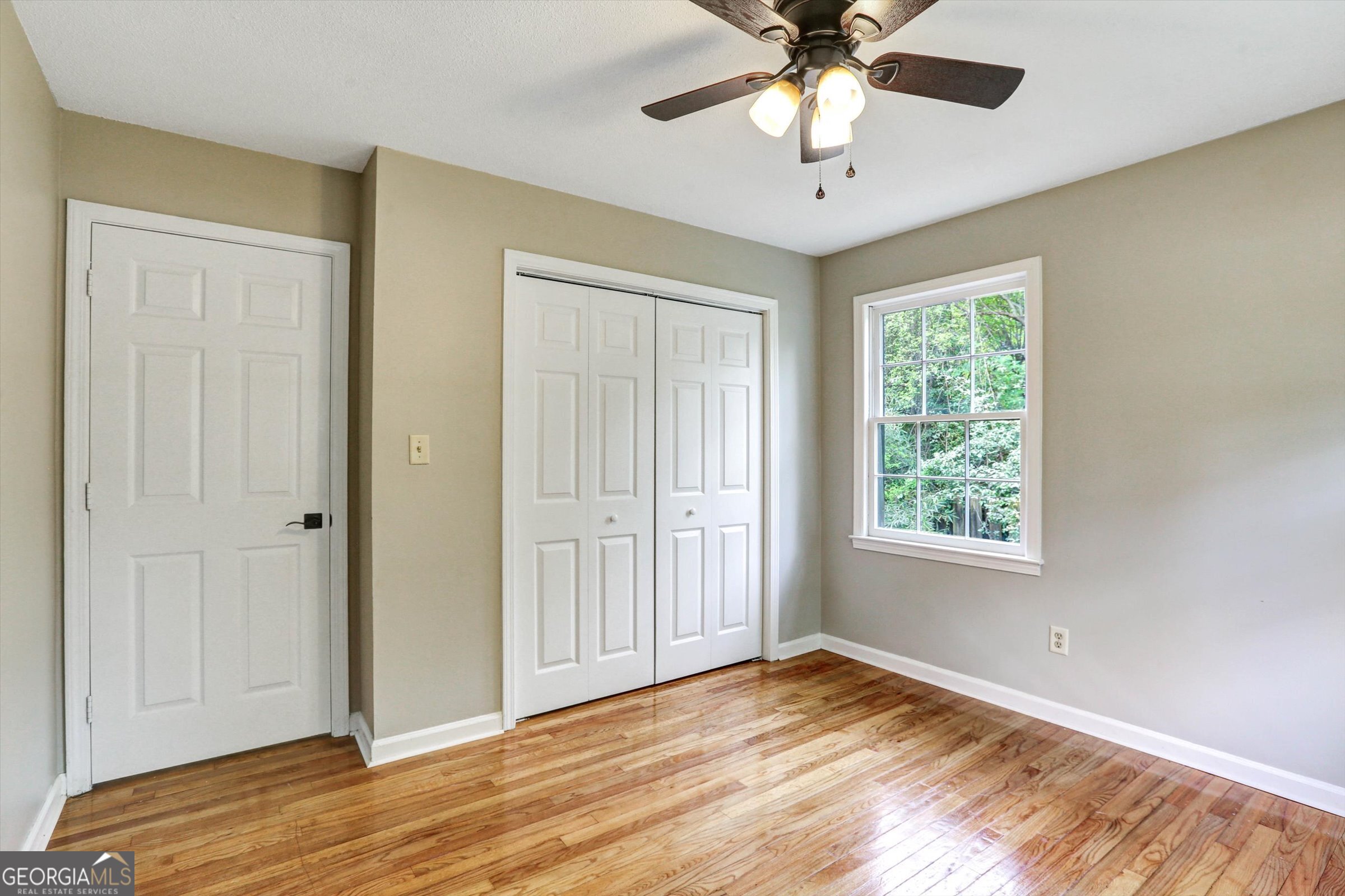1095 Athens Road Winterville, GA 30683 - Photo 22 of 32 a view of an empty room with window and wooden floor