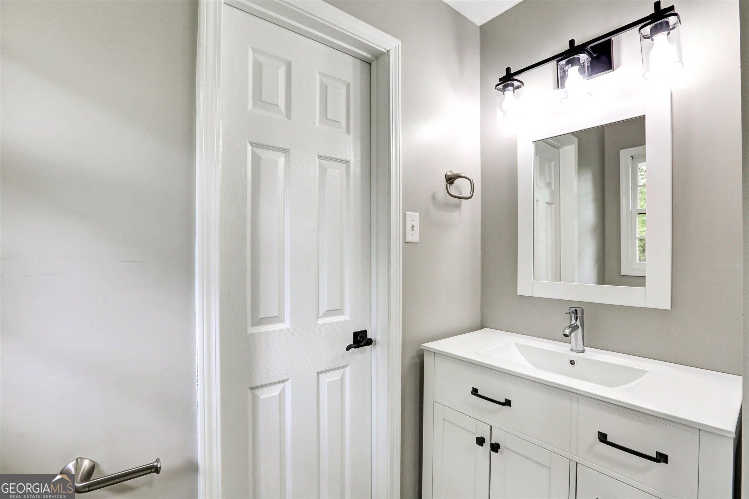 1095 Athens Road Winterville, GA 30683 - Photo 26 of 32 a bathroom with a sink and a mirror