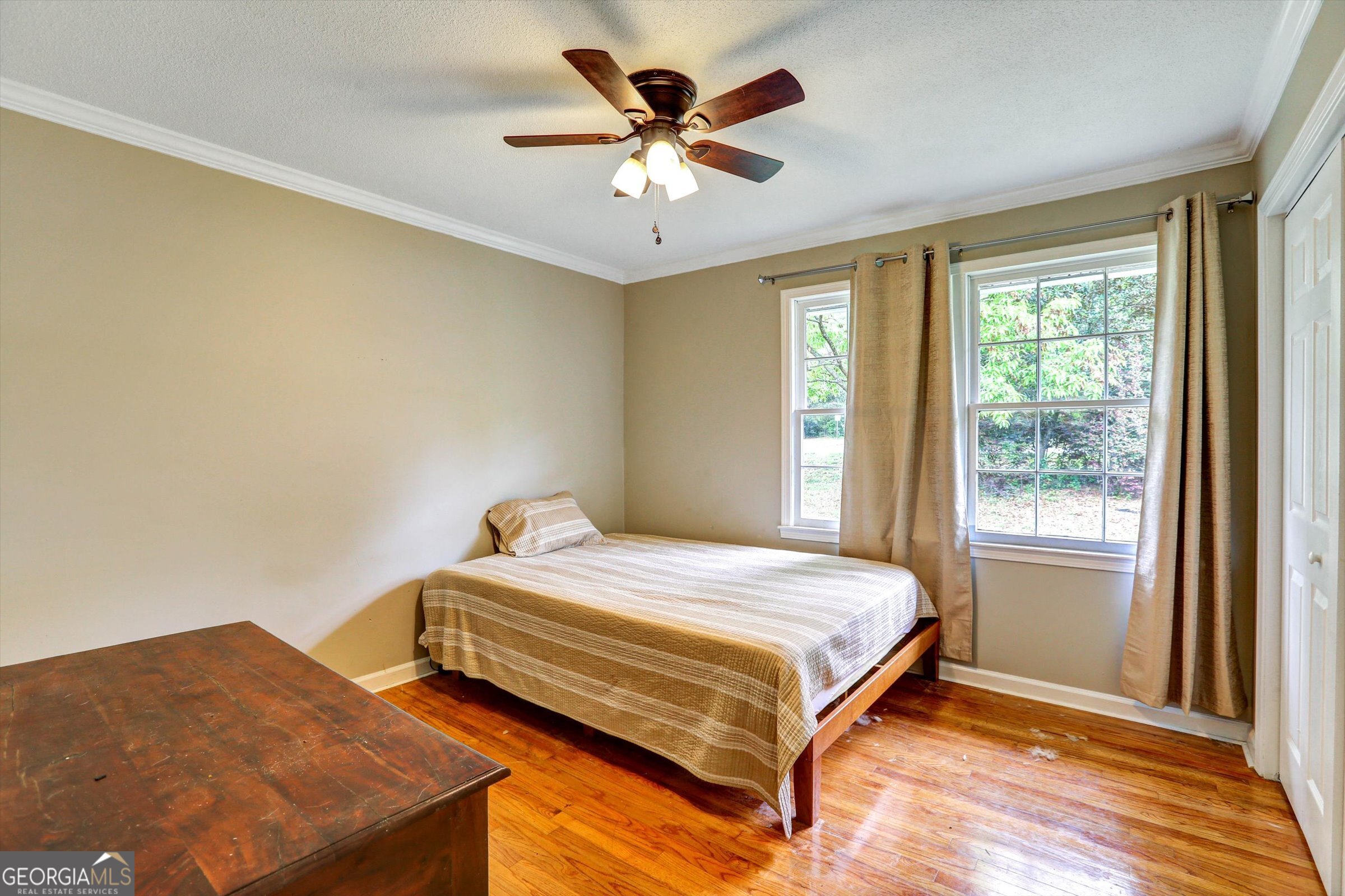1095 Athens Road Winterville, GA 30683 - Photo 27 of 32 a bedroom with a bed and a chandelier