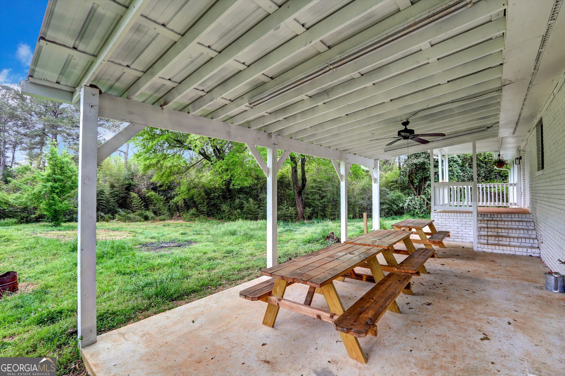 1095 Athens Road Winterville, GA 30683 - Photo 31 of 32 a view of a patio with table and chairs next to a yard