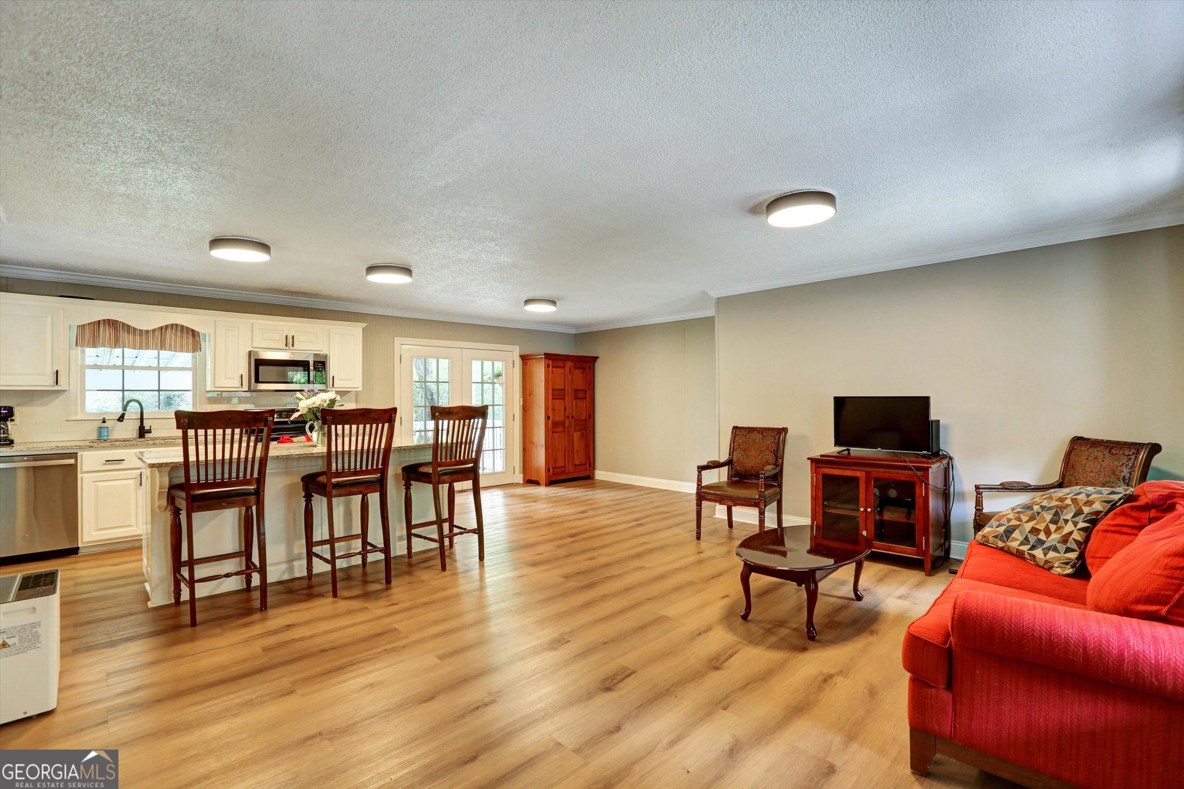 1095 Athens Road Winterville, GA 30683 - Photo 6 of 32 a living room with furniture and a wooden floor
