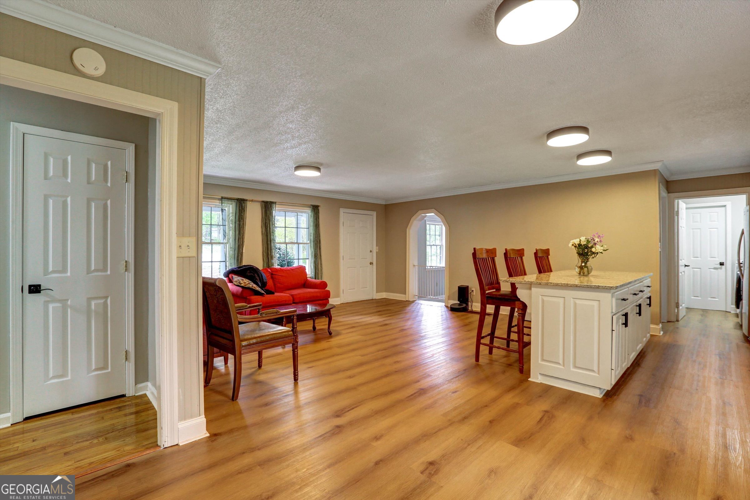 1095 Athens Road Winterville, GA 30683 - Photo 8 of 32 a living room with furniture and a wooden floor