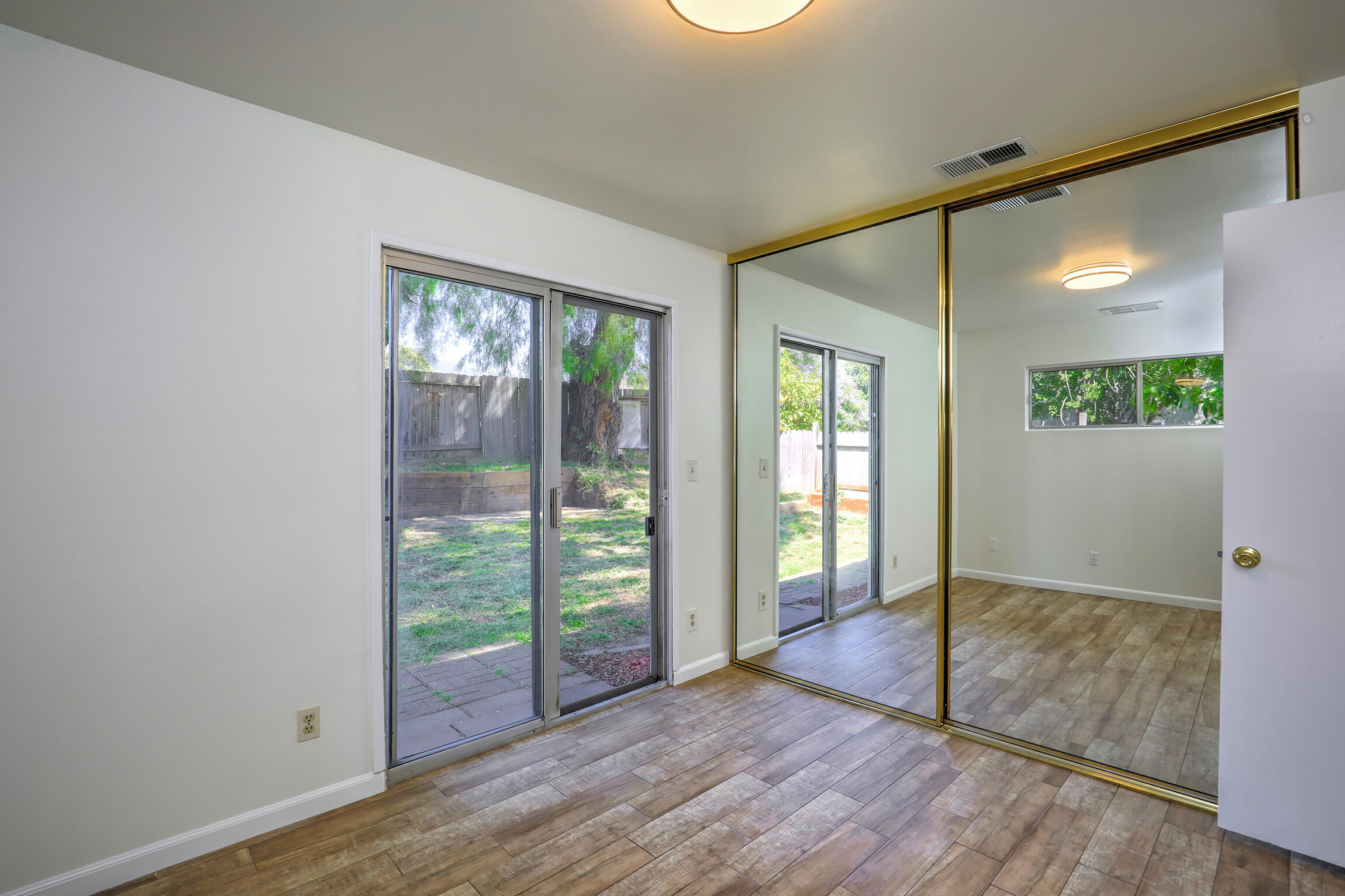 5058 Rocoso Way Santa Barbara, CA 93111 - Photo 13 of 19 an empty room with wooden floor and windows