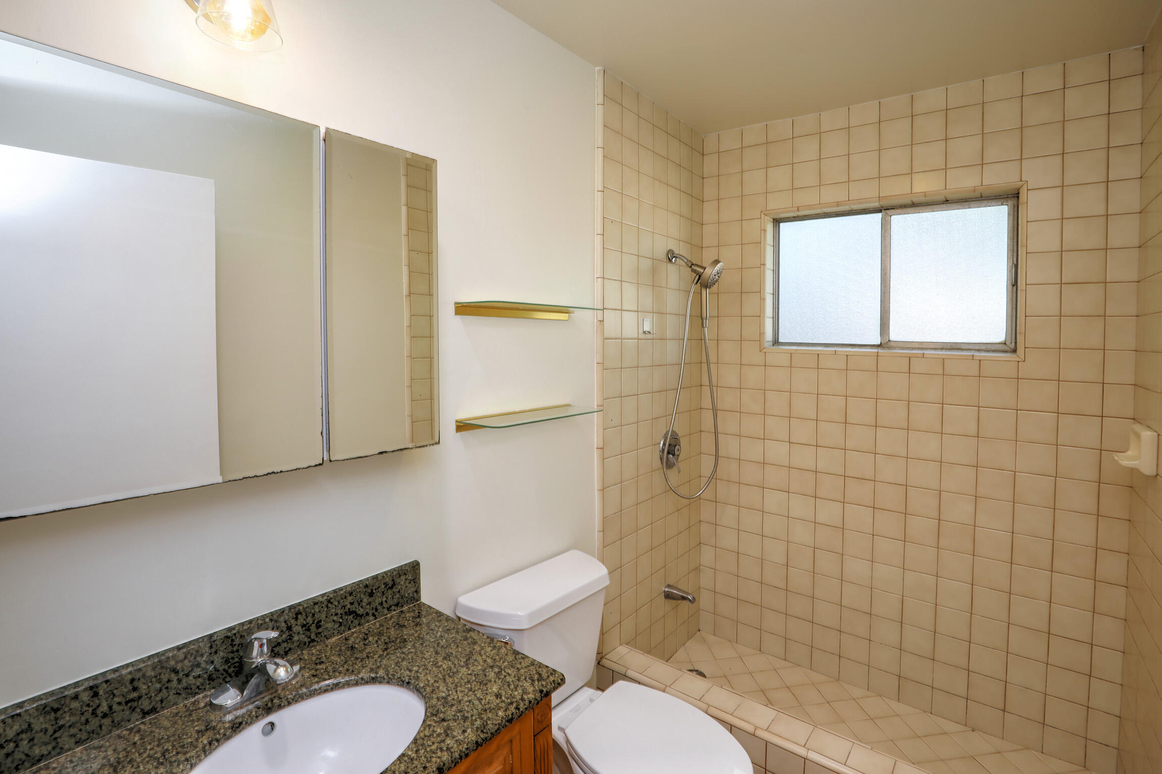 5058 Rocoso Way Santa Barbara, CA 93111 - Photo 14 of 19 a white toilet sitting next to a bathroom sink and a shower