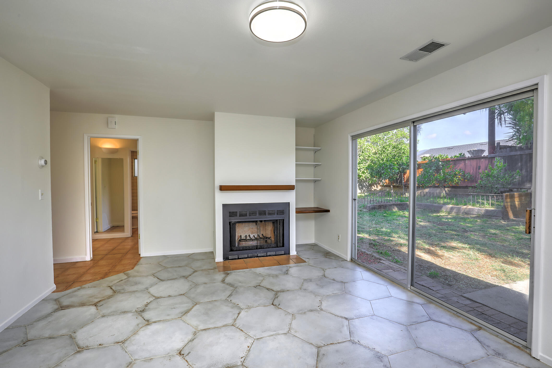 5058 Rocoso Way Santa Barbara, CA 93111 - Photo 2 of 19 a view of empty room with fireplace and fan