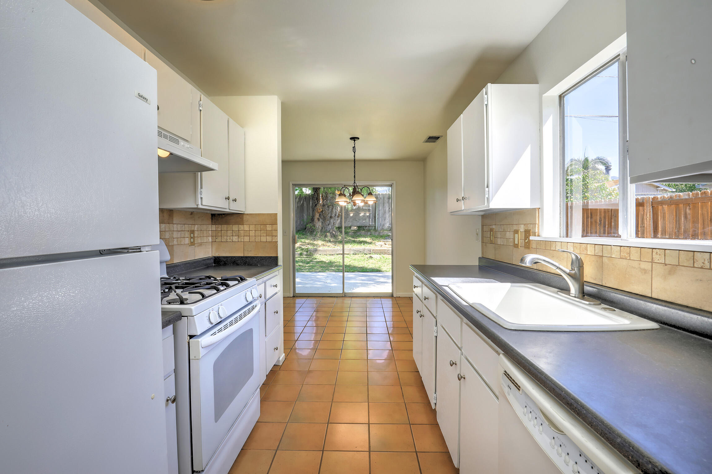 5058 Rocoso Way Santa Barbara, CA 93111 - Photo 5 of 19 a large kitchen with stainless steel appliances granite countertop a sink stove and refrigerator
