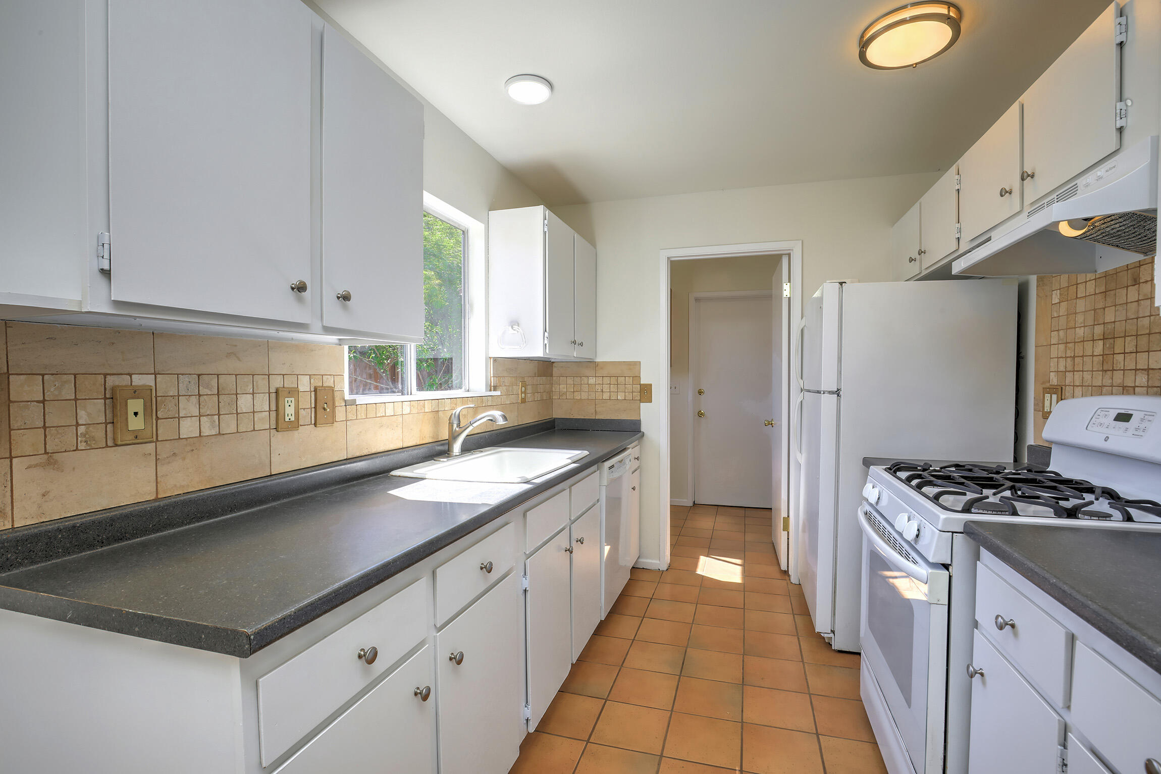 5058 Rocoso Way Santa Barbara, CA 93111 - Photo 6 of 19 a kitchen with stainless steel appliances granite countertop a sink stove and cabinets