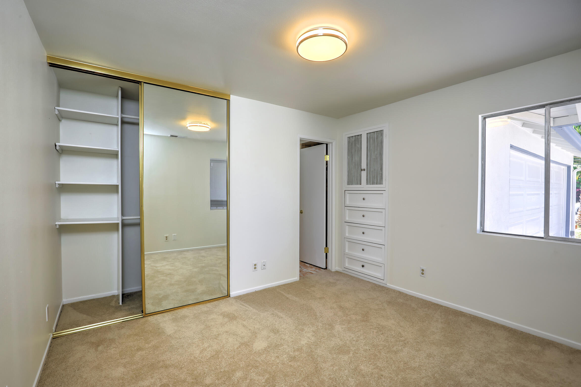 5058 Rocoso Way Santa Barbara, CA 93111 - Photo 9 of 19 an empty room with closet and windows
