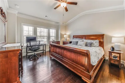 a bed room with a bed and a chair