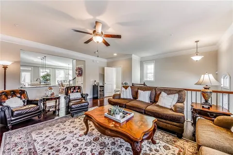 a living room with furniture a rug and a chandelier