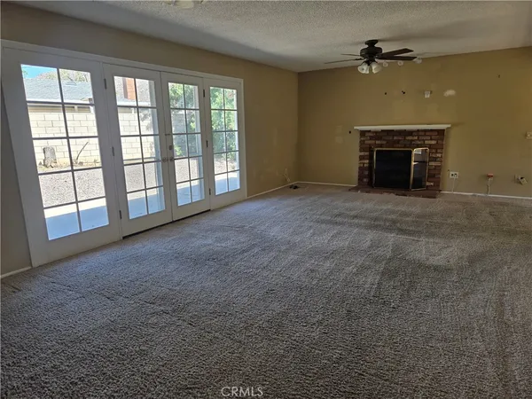 a view of empty room with a fireplace
