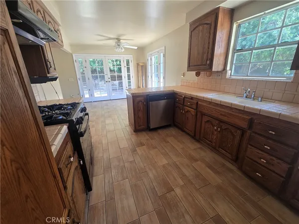a kitchen with a sink appliances and a window