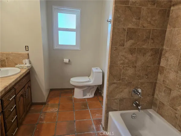 a bathroom with a sink a toilet and bathtub