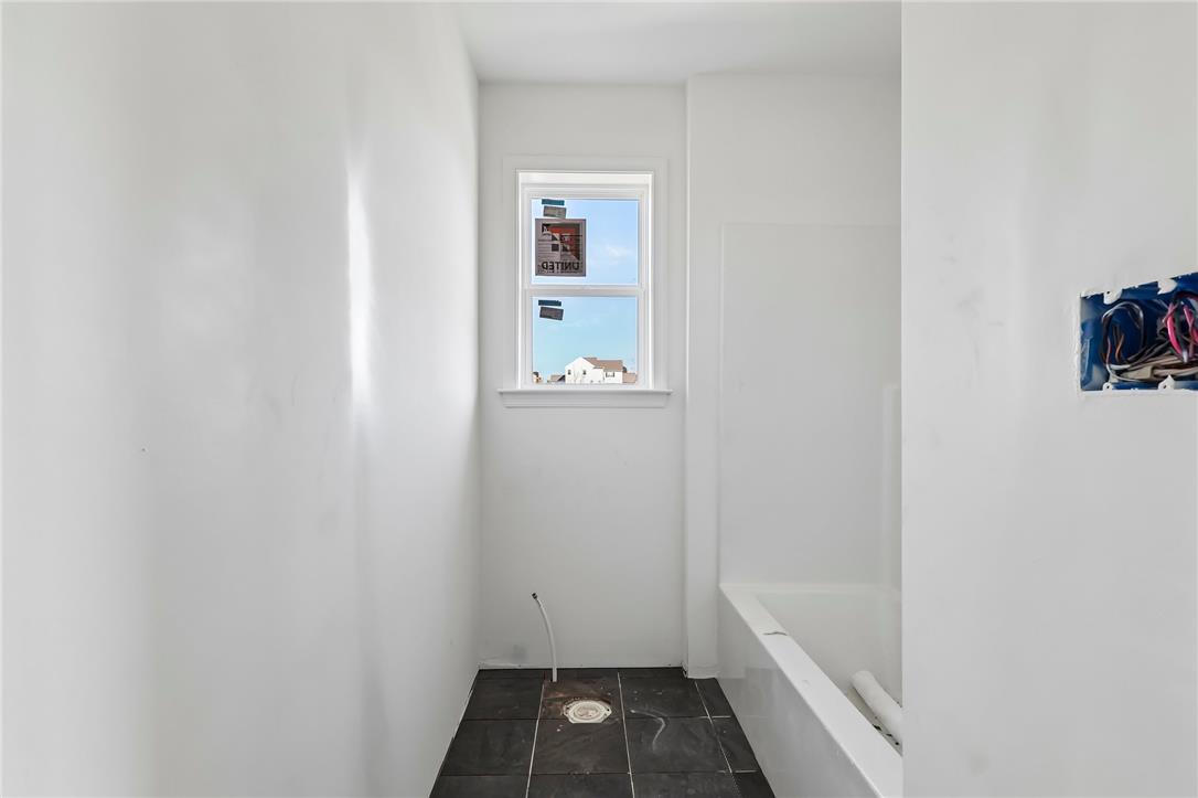 3237 Michaels School Road, Unit 9 Nazareth, PA 18064 - Photo 38 of 56 A single window provides natural light to this unfinished bathroom space featuring dark floor tiling.