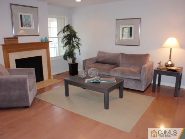 41 Raritan Reach Road, Unit 21 South Amboy, NJ 08879 - Photo 7 of 23 a living room with furniture and a fireplace
