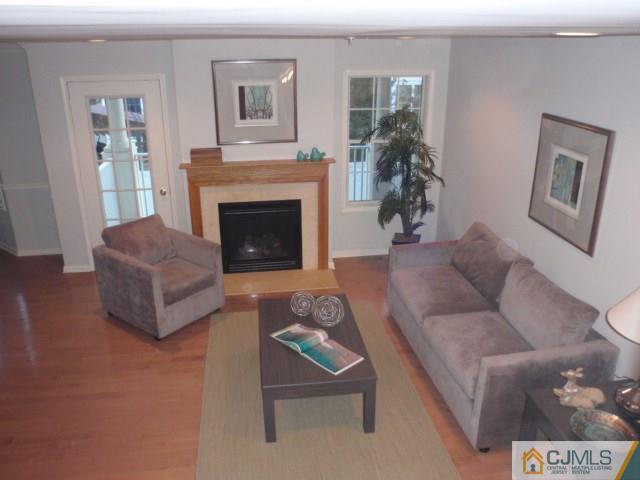 41 Raritan Reach Road, Unit 21 South Amboy, NJ 08879 - Photo 8 of 23 a living room with furniture and a fireplace