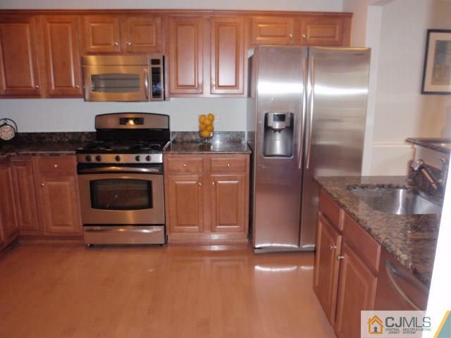 41 Raritan Reach Road, Unit 21 South Amboy, NJ 08879 - Photo 9 of 23 a kitchen with stainless steel appliances granite countertop a refrigerator a stove a sink and a granite counter tops