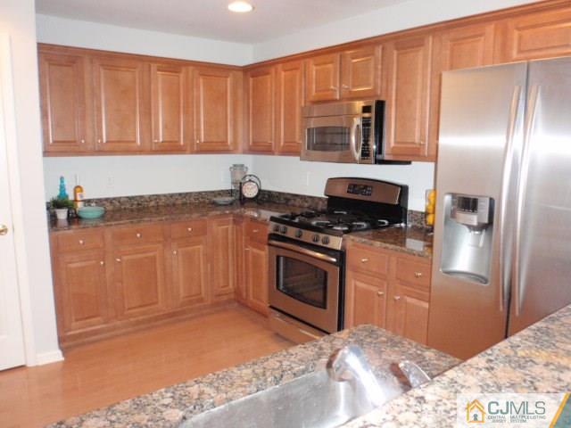 41 Raritan Reach Road, Unit 21 South Amboy, NJ 08879 - Photo 10 of 23 a kitchen with granite countertop a refrigerator stove and oven