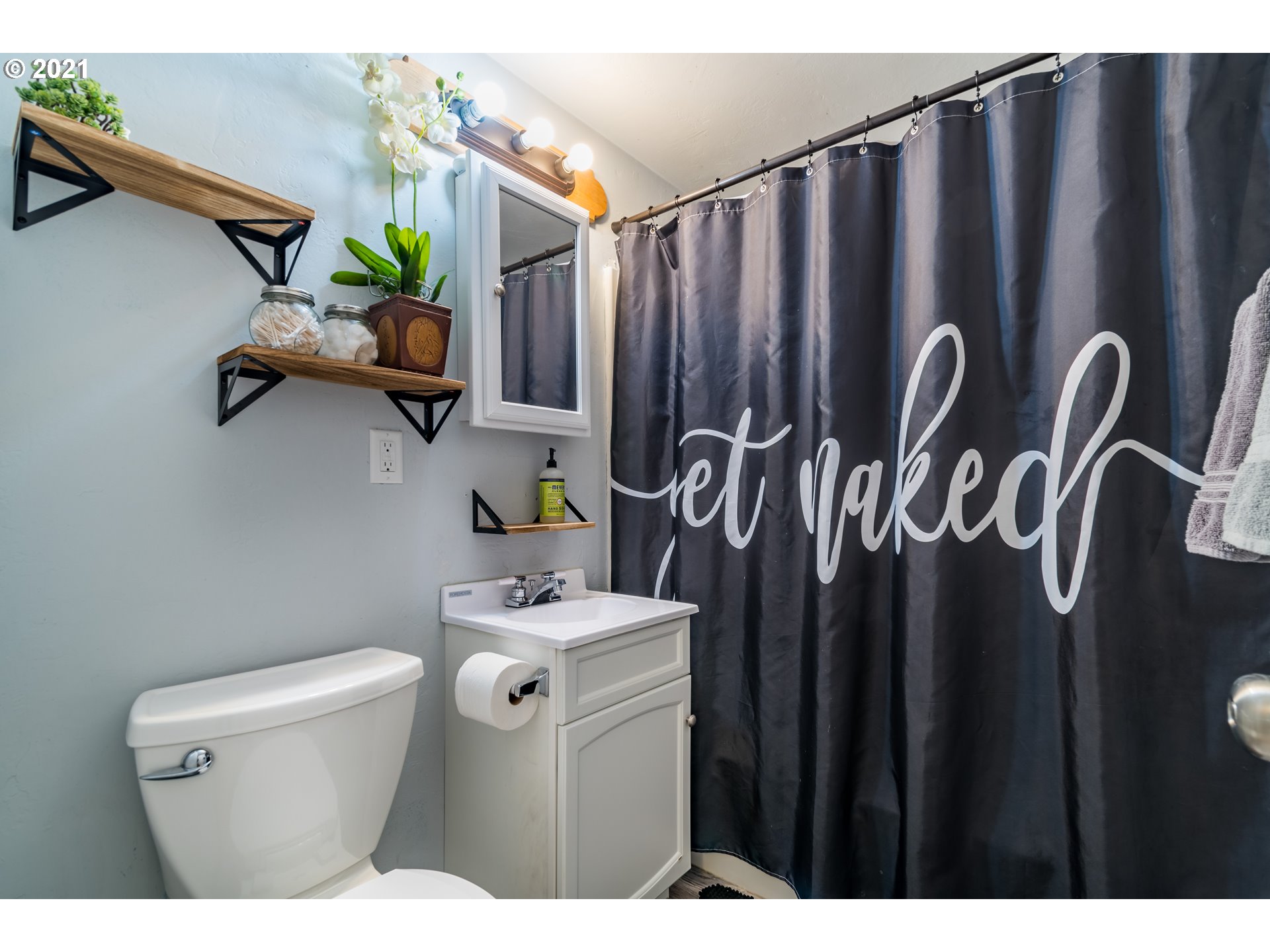 5195 E Street Springfield, OR 97478 - Photo 20 of 30 a bathroom with a toilet a sink and curtain