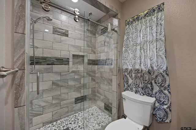 a bathroom with a toilet and shower