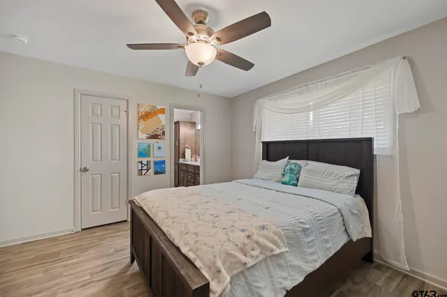 a bedroom with a bed and a chandelier