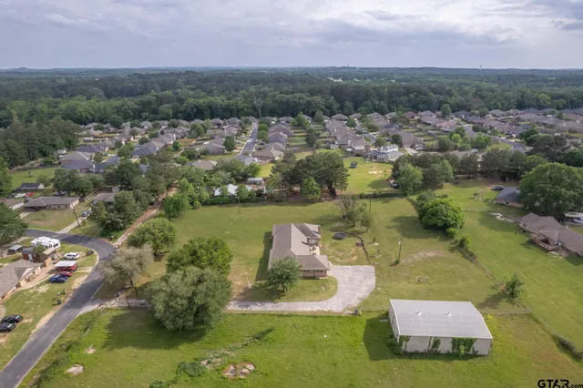 an aerial view of a houses with a lake view