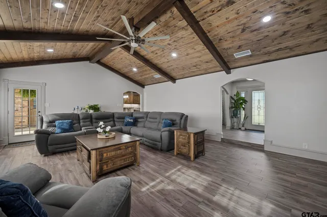 a living room with furniture and a wooden floor