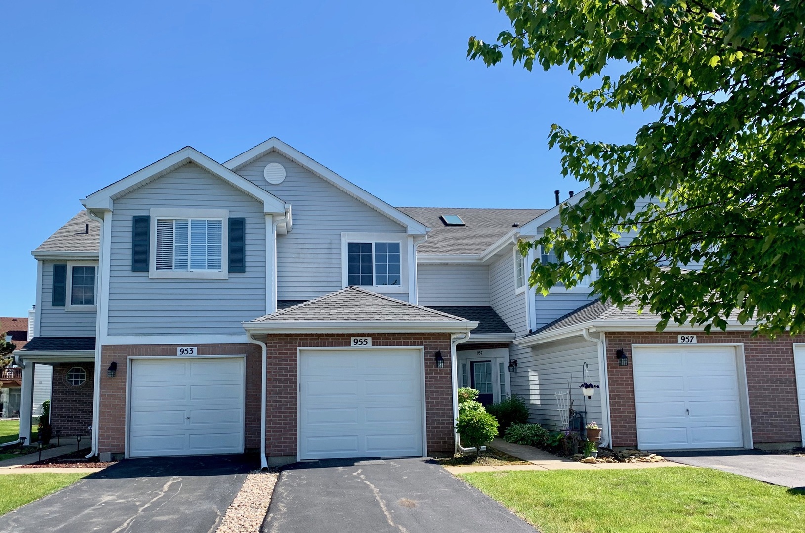 955 Ripple Ridge Cove, Unit 955 Darien, IL 60561 - Photo 1 of 13 a front view of a house with a garden and plants