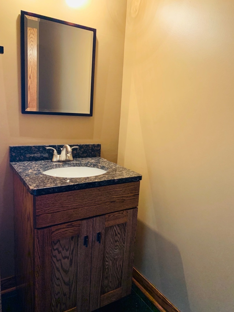 955 Ripple Ridge Cove, Unit 955 Darien, IL 60561 - Photo 6 of 13 a bathroom with a sink and a mirror