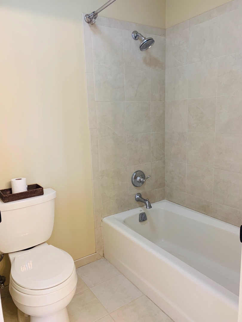 955 Ripple Ridge Cove, Unit 955 Darien, IL 60561 - Photo 9 of 13 a white toilet sitting next to a bath tub
