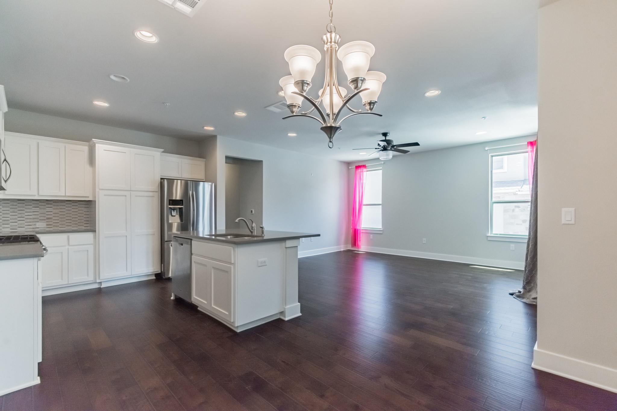 13800 Lyndhurst Street, Unit 221 Austin, TX 78717 - Photo 14 of 40 a kitchen with stainless steel appliances granite countertop a refrigerator a sink dishwasher a stove and white cabinets with wooden floor