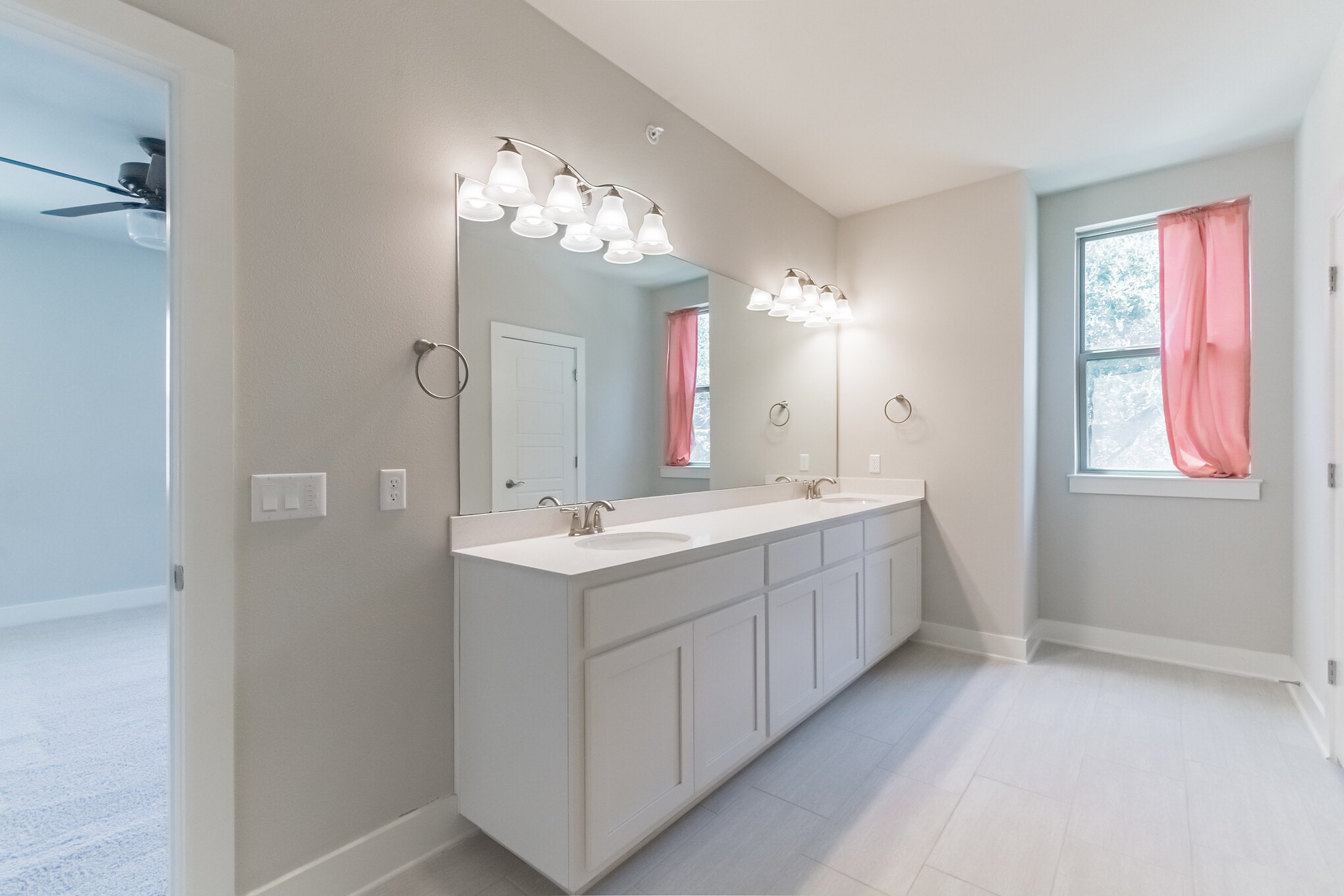13800 Lyndhurst Street, Unit 221 Austin, TX 78717 - Photo 24 of 40 a spacious bathroom with a double vanity sink a large mirror and a shower