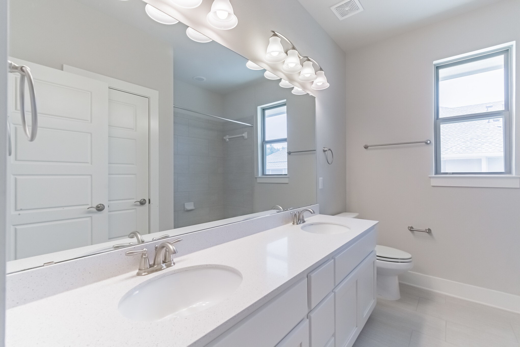 13800 Lyndhurst Street, Unit 221 Austin, TX 78717 - Photo 30 of 40 a bathroom with a double vanity sink mirror and toilet