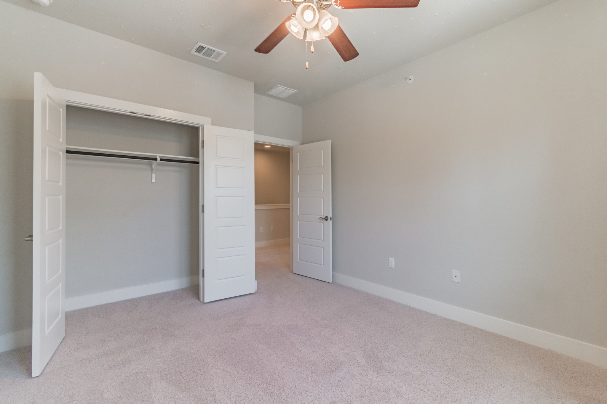 13800 Lyndhurst Street, Unit 221 Austin, TX 78717 - Photo 34 of 40 an empty room with closet and a chandelier fan