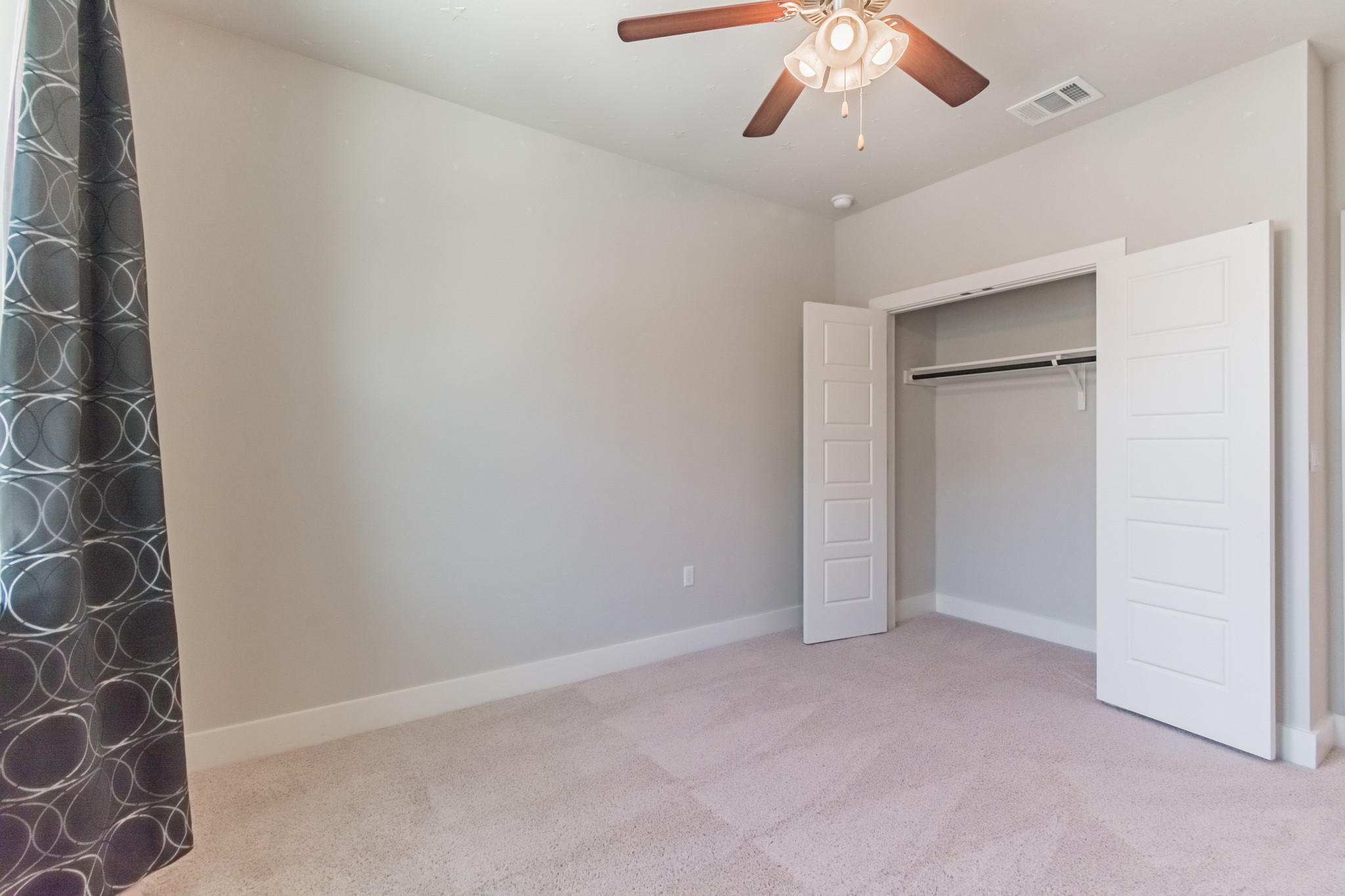 13800 Lyndhurst Street, Unit 221 Austin, TX 78717 - Photo 35 of 40 an empty room with a ceiling fan and carpet