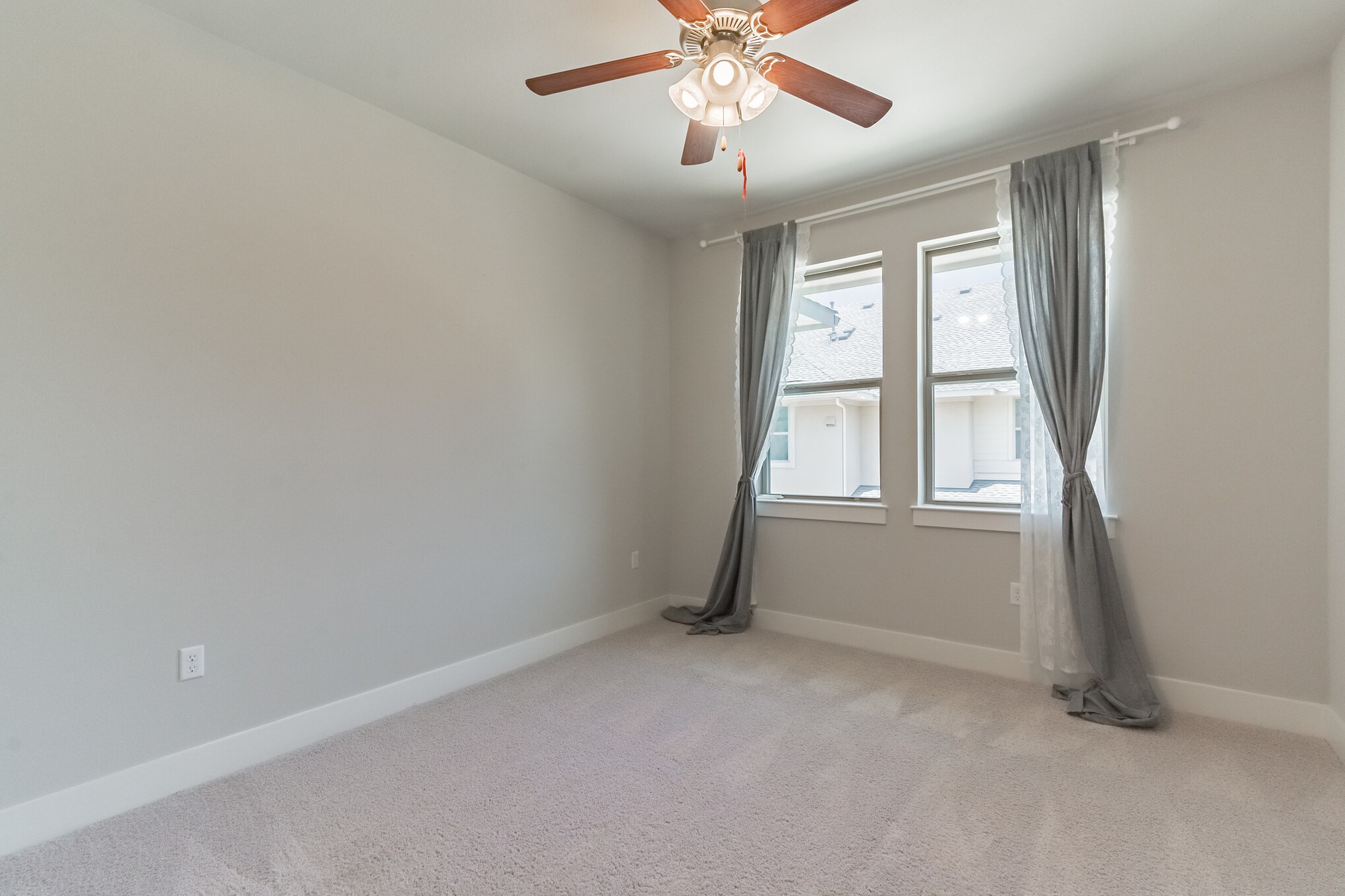 13800 Lyndhurst Street, Unit 221 Austin, TX 78717 - Photo 36 of 40 an empty room with windows and fan