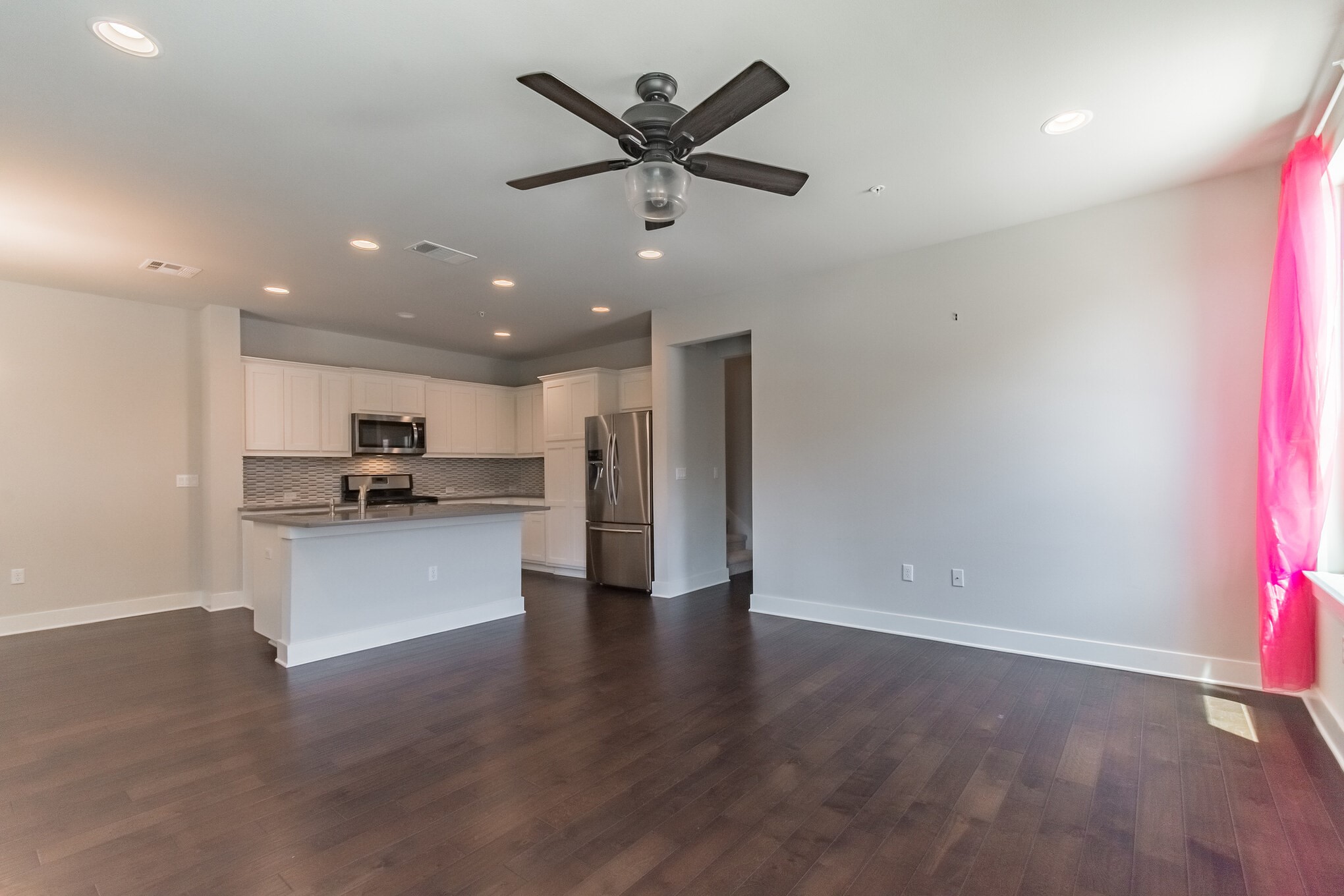 13800 Lyndhurst Street, Unit 221 Austin, TX 78717 - Photo 9 of 40 a view of kitchen with kitchen island wooden floors appliances and cabinets